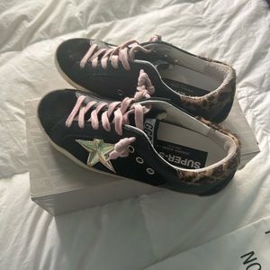 Black super star golden goose sneakers with cheetah print back